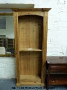 A tall pine pedimented bookcase with adjustable shelves (width 75cm, depth 27cm,