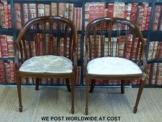 A pair of Edwardian lounge chairs with spar backs and string inlay.