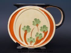 A Myott & Son Art Deco footed and relief moulded circular jug with hand painted flower decoration