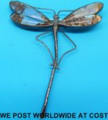 A silver Art Nouveau damselfly brooch with butterfly wing decoration