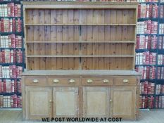A large pine dresser with plate rack above,
