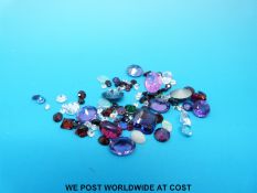 A collection of gemstones to include amethysts, opals,