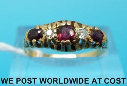 An 18ct gold ring set with alternating garnets and diamonds (size Q)