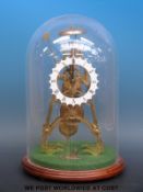 A skeleton clock striking on a bell, with key, under glass dome, no maker's mark to fusee movement,