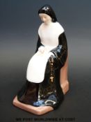 A Coalport figure of a nun