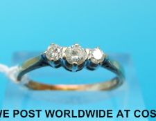 A yellow metal ring set with three diamonds (size O)