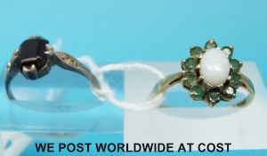 A 9ct gold ring set with an opal and emeralds and a 9ct gold and silver ring set with a garnet