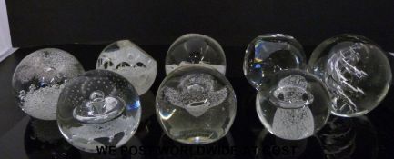 Eight Caithness clear glass paperweights,