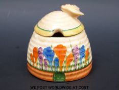 A Clarice Cliff Crocus pattern honey pot with bee finial (7cm tall)