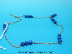 A 9ct gold necklace set with lapis lazuli beads