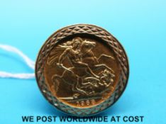 A 9ct gold ring set with a 1968 gold full sovereign (14g)