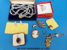 A collection of costume jewellery including a cameo, a watch, beads,