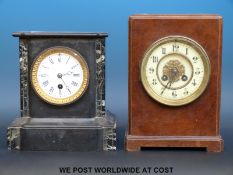 Two French mantel clocks one a black slate timepiece with enamelled dial,