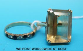 A 9ct gold ring set with alternating sapphires and diamonds and a yellow metal ring set with smoky