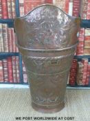 A large Austrian 19thC copper log carrier with relief moulded decoration of a double headed eagle.