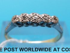 An yellow metal ring marked 18ct set with five diamonds in a platinum setting (size P)