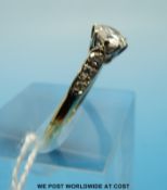 An 18ct gold ring set with a round brilliant cut diamond of approximately 0.