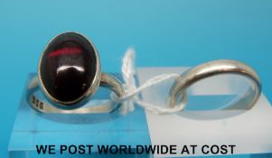 A silver ring set with a ruby cabochon and a silver wedding band (size M)