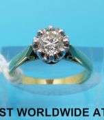 An 18ct gold ring set with a round cut diamond measuring approximately 0.