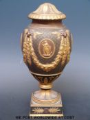 A Wedgwood black basalt pedestal vase and cover with unusual gilt decoration,