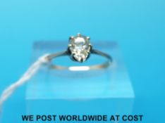 A yellow metal ring set with a pear cut diamond measuring approximately 0.