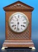 An oak cased mantel clock raised on brass bracket feet, shooting star trade mark to movement,
