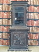A carved oak double height corner cupboard with glazed top section (height 203cm)