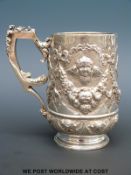 A Victorian hallmarked silver tankard with embossed decoration, London 1886,
