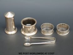 Two hallmarked silver napkin rings and a pair of sugar tongs (35g) together with a hallmarked