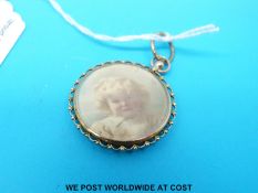 A 9ct gold mount with a portrait miniature of a young girl by Florence set between two pieces of