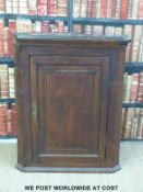 A 19thC oak hanging corner cupboard (94cm tall x 75cm wide x 42cm deep)
