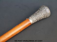 A Malacca walking cane with embossed white metal top, probably Indian,