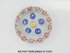 St Louis rondello patterned millefiori glass paperweight with central red,