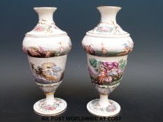 A pair of Capodimonte pedestal vases decorated with semi-nude figures playing musical instruments
