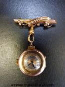 Swiss 9ct gold nurse's watch and bar brooch with blued hands and Arabic numerals on turned bi-metal