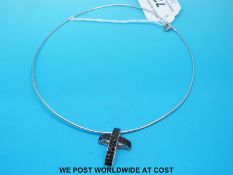 An 18ct white gold necklace with an 18ct white gold pendant set with black diamonds in a cross by