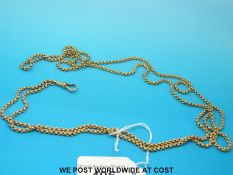 An unusually long late 19thC / early 20thC guard chain marked 15ct with 75cm drop (50.