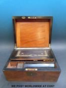 A walnut writing slope with a collection of wallets, two hip flasks,