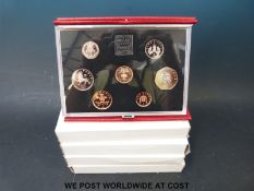 Four 1980's UK proof coin sets in deluxe cases including 1984, 1985,