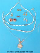 A single strand of pearls with a 9ct gold clasp set with a diamond, another pearl necklace,