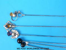 Three silver topped hat pins in the form of thistles set with amethysts and citrine together with