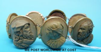 A yellow metal bracelet set with seven lava cameos