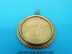 A 9ct gold pendant set with a 1oz 1975 Krugerrand (37.