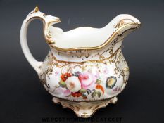 A 19thC hand painted Coalport or Spode footed cream jug hand decorated with flowers