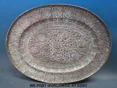 A copper tray with relief moulded decoration of chrysanthemums