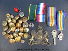 A collection of militaria including regimental buttons, badges,