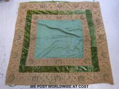 A late Victorian bed cover in dark green brocade and velvet with tapework decoration to the border