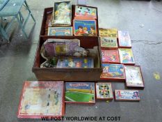 A vintage metal trunk full of toys and board games.