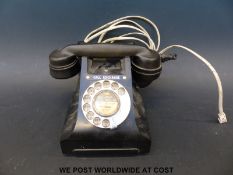 A black bakelite GPO S12/L FWR 65/3A telephone with modern connection