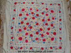 A 19thC Chinese silk shawl very finely embroidered with birds among flowers,